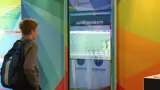 Portrait digital screen display built into a themed wall
