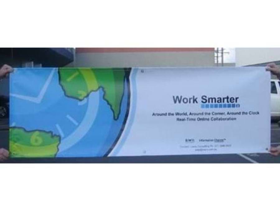 Printed outdoor banner with a clock face and map graphic and the headline Work Smarter, held up at its corners