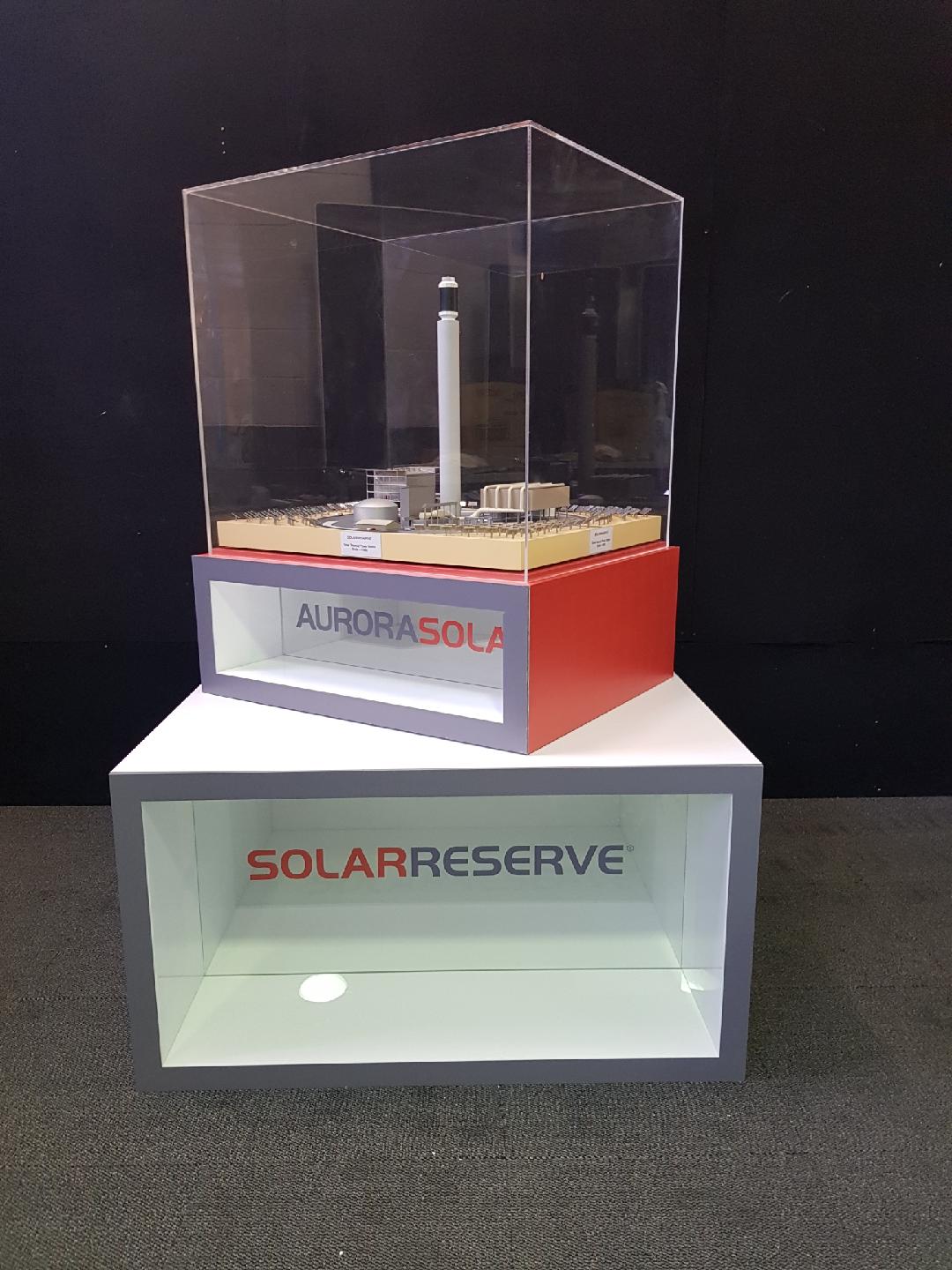 SolarReserve branded plinth with a clear acrylic display case over a scale model