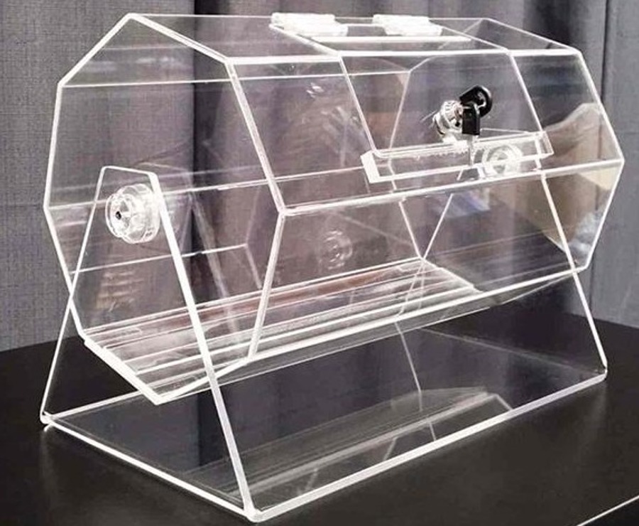 Clear acrylic hexagonal raffle barrel with a hinged locking door and key, on an acrylic stand