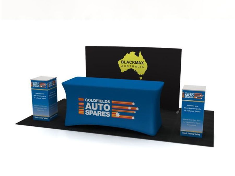 Render of a mall registration kit: a black backdrop wall, a trestle table in a fitted blue printed cover and two printed plinths on a dark floor mat