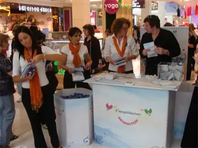 Weight Watchers counter in light blue with handouts on top and a matching branded bin