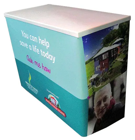 Teal Prince of Wales charity counter with a white top and photos on its side