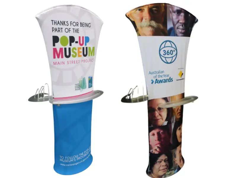 Display banner with built-in shelves and brochure holder
