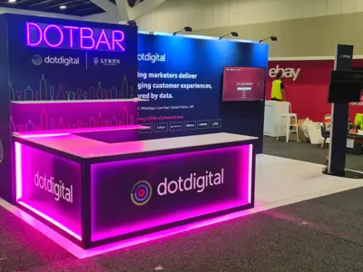 Pink LED-lit DOTBAR corner counter under neon-style lettering on the dotdigital stand