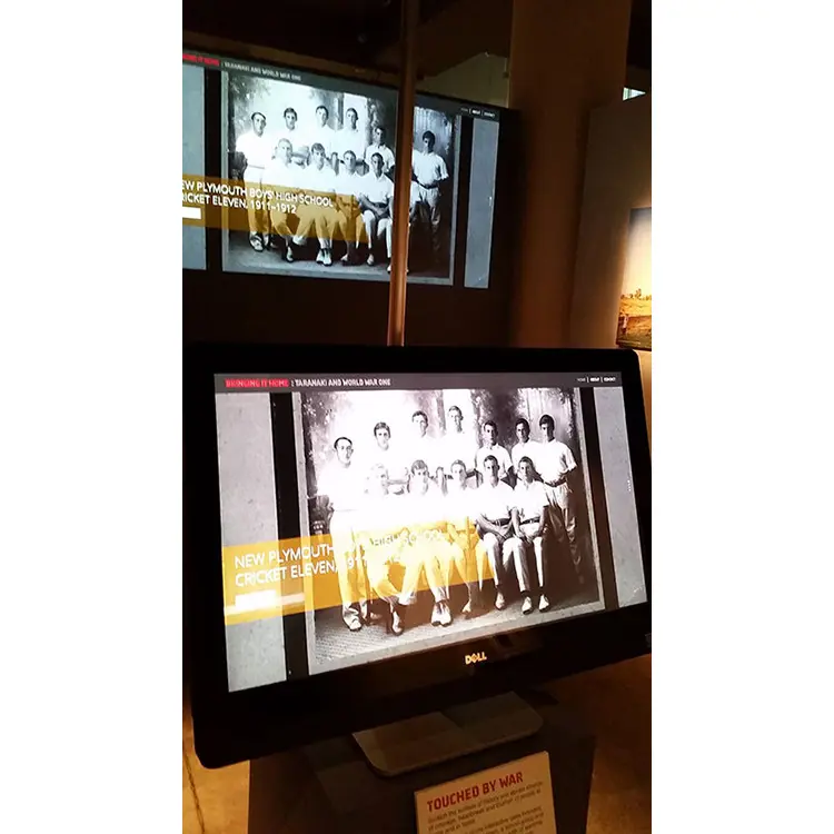 Taranaki and World War One exhibit screens showing a 1911 school cricket eleven