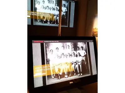 Taranaki and World War One exhibit screens showing a 1911 school cricket eleven