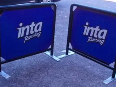 Black-framed inta Racing cafe barriers with blue printed panels on flat steel feet
