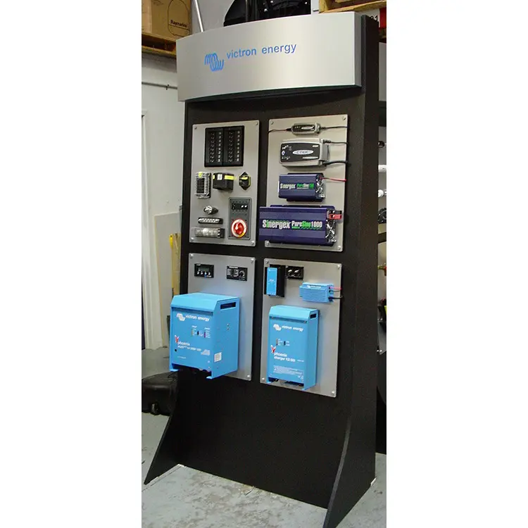 Victron Energy stand with electrical components on aluminium panels and two blue Phoenix chargers