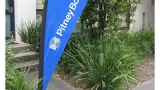 Teardrop flag beside a business entrance