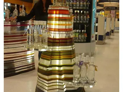 Striped 42 Below acrylic stand in a liquor store with a large bottle on top