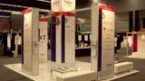 Raised floor exhibition stand with tall info towers