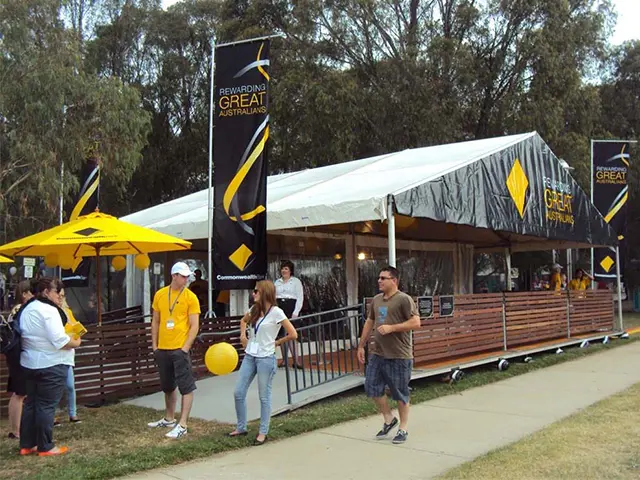 Commonwealth Bank marquee with clear walls, a ramped entry and black and yellow flags