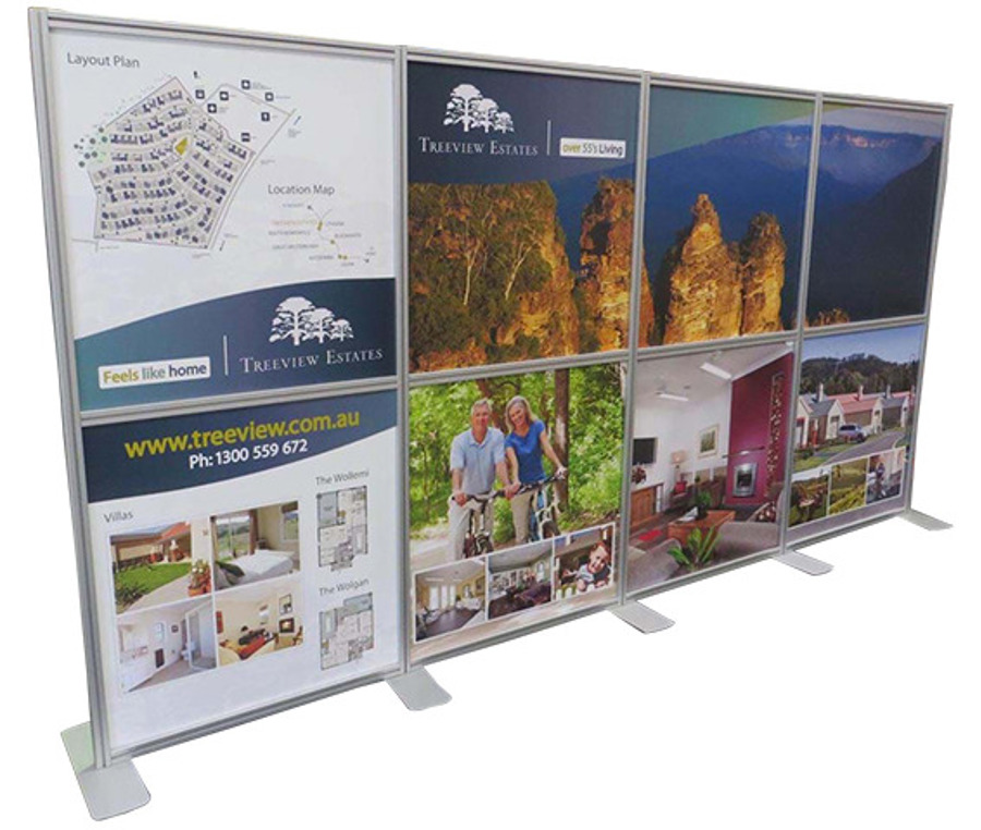 Freestanding aluminium poster wall holding eight printed panels for a residential estate, including a site plan and floor plans