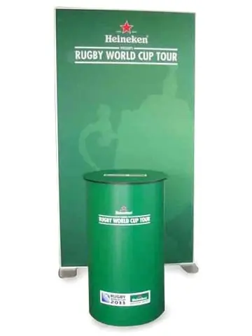 Green Heineken Rugby World Cup Tour backdrop behind a round branded lectern