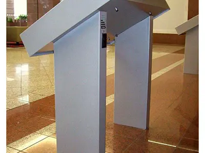 Silver-grey lectern with a sharply angled top on twin uprights in a corporate lobby