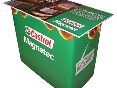 Green Castrol Magnatec demo counter with engine imagery printed across the top