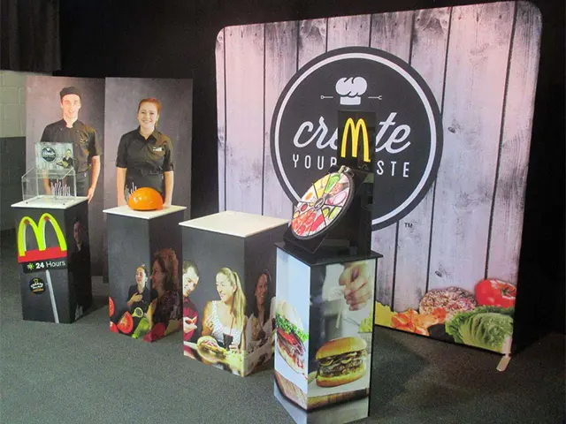 McDonald's prize wheel on a plinth in front of a timber-look curved fabric wall
