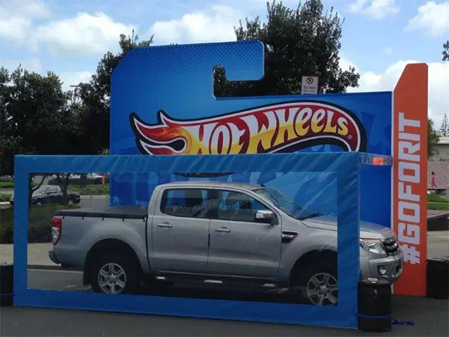 Silver ute inside a giant blue Hot Wheels blister pack with an orange #GOFORIT panel