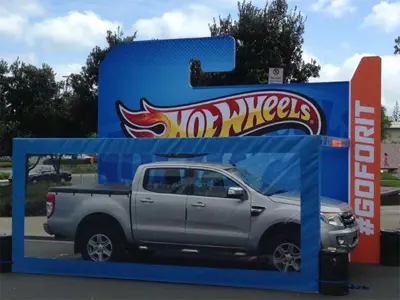 Silver ute inside a giant blue Hot Wheels blister pack with an orange #GOFORIT panel