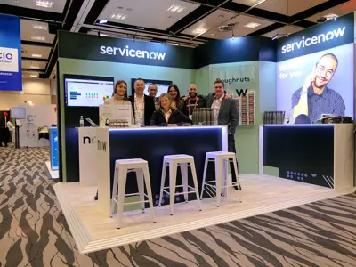 ServiceNow bar counter with LED edge lighting and white stools on a raised timber-look floor