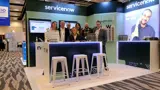 Expo booth with lit bar counter on a raised timber floor