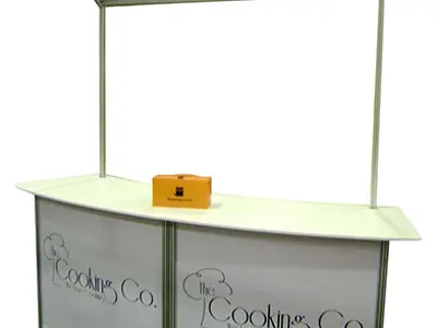The Cooking Co. counter with a curved white bench and a mirror on two posts