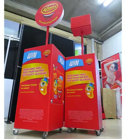 Red Allen's competition bins on castors with jelly bean packs and round header signs