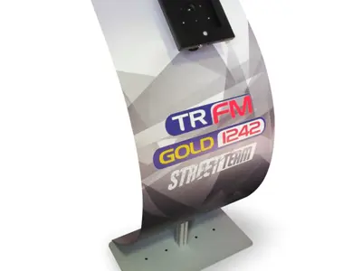 Curved tablet stand printed with TR FM, Gold 1242 and Street Team logos