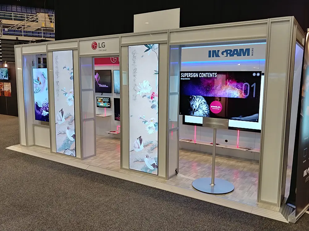 LG and Ingram Micro booth with tall bird-and-flower screens set in a white frame