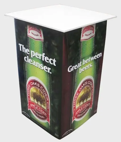 Three Oaks Cider demo table wrapped with a bottle image and a clear white top