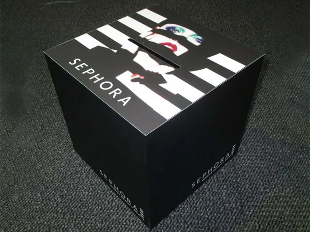 Sephora cube with black-and-white stripes, make-up imagery on top and a slot through the artwork