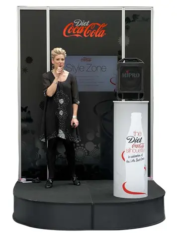 Curved black stage with a Diet Coca-Cola Style Zone back wall and bottle-printed round plinth