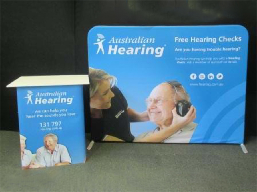 Australian Hearing fabric display wall with a matching printed counter, a compact kit for a shopping centre site