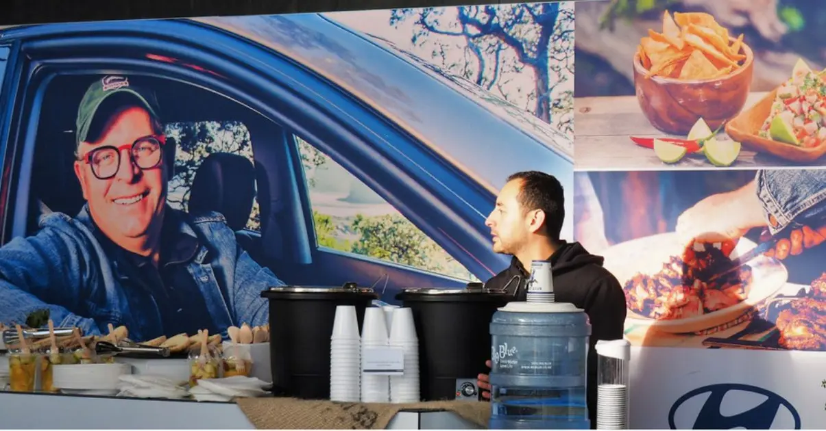 Hyundai backdrop with lifestyle and food photography behind an event catering counter