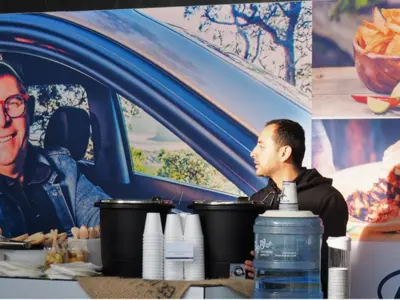 Hyundai backdrop with lifestyle and food photography behind an event catering counter