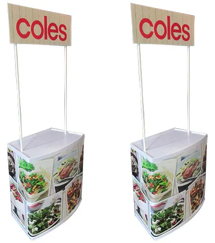 Matching pair of Coles demo tables with food photo fronts and white worktops