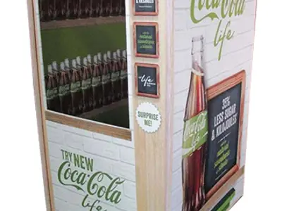 Coca-Cola Life vending display with a bottle-filled window under a green and white scalloped awning