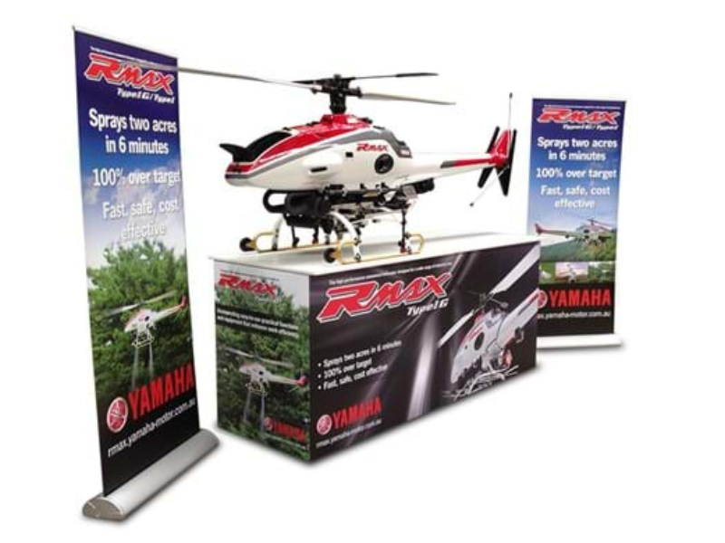 Yamaha RMAX branded custom plinth counter with pull-up banners