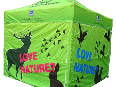 RSPB marquee wrapped in bright green Love Nature artwork with wildlife silhouettes on every wall