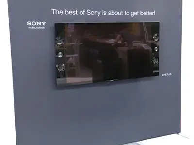 Grey fabric Sony Xperia wall with a built-in TV screen and speakers on slim feet