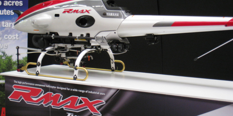 Yamaha RMAX remote-control helicopter mounted on its branded display plinth