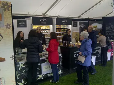 Kapiti cheese and ice cream counters with fridges and a menu board under a marquee