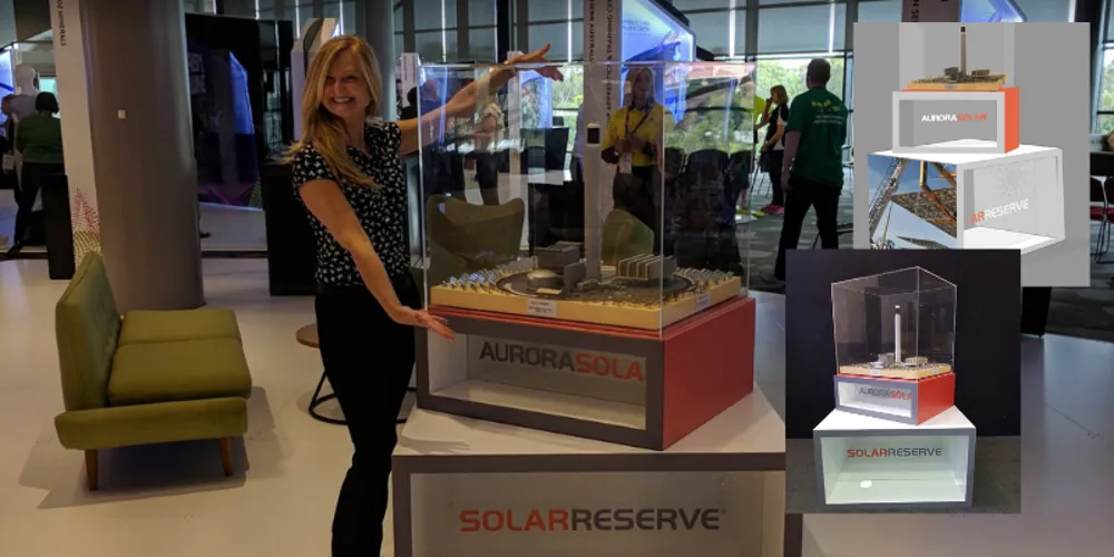 SolarReserve showcase cubes with clear acrylic tops holding scale models at an event