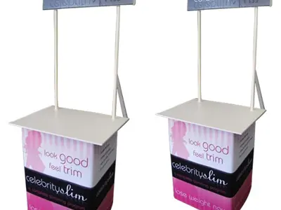 Two pink and black Celebrity Slim counters with header signs raised on slim poles