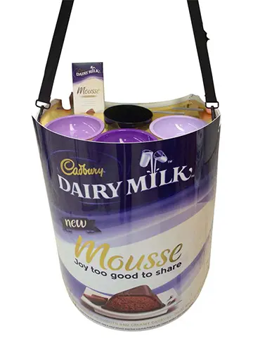 Promoter wearing a Cadbury Dairy Milk Mousse tray on a shoulder strap, with sample bowls