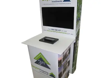 Dwyer Property Investments counter with a tablet in the top and a screen above