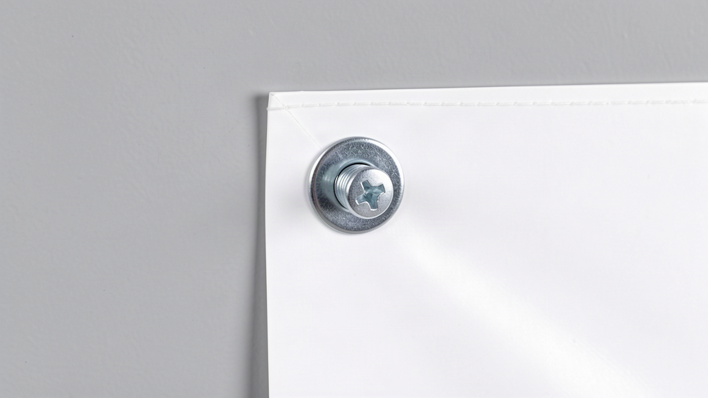 PVC banner fixed to a wall with a screw and washer through the corner eyelet