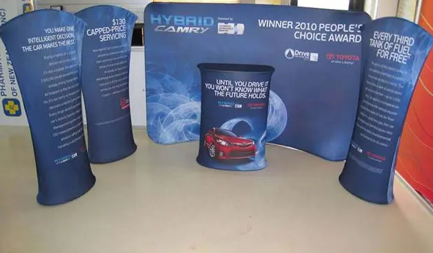 Toyota Hybrid Camry curved backdrop with three tall fabric towers and a printed counter