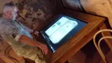 Interactive screen table with a bevelled timber frame
